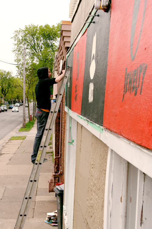 Zach Pearl paints Blacklist Vintage storefront